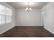Open room design featuring wood floors, neutral paint, and classic chandelier at 302 Shiloh Way, Mebane, NC 27302