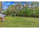 View of the backyard featuring a spacious lawn and wooded perimeter for privacy at 308 Plaza Dr, Garner, NC 27529
