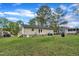Backyard view showcasing the home's exterior with siding and a well-maintained lawn at 308 Plaza Dr, Garner, NC 27529
