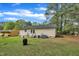 A well-maintained backyard with a view of the home's exterior and mature trees at 308 Plaza Dr, Garner, NC 27529