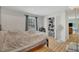 Bright bedroom with window, closet, neutral walls, and wood-look floors at 308 Plaza Dr, Garner, NC 27529