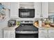 Modern kitchen featuring stainless steel appliances and white cabinets at 308 Plaza Dr, Garner, NC 27529