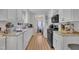 Bright kitchen with white cabinets, countertops, and modern appliances at 308 Plaza Dr, Garner, NC 27529