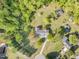 Aerial view of a home featuring lush greenery, mature trees, a winding driveway, and a sizeable well-kept lawn at 317 William Dr, Benson, NC 27504