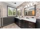 Elegant bathroom with dual vanities, marble countertops, mosaic tile accent wall, and ample lighting at 317 William Dr, Benson, NC 27504