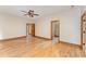 Inviting bedroom with hardwood floors, ceiling fan, natural light, and access to two ensuite bathrooms at 317 William Dr, Benson, NC 27504