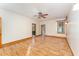 Bright bedroom featuring hardwood floors, natural light, ceiling fan, and ensuite bath with wood trim around windows and doors at 317 William Dr, Benson, NC 27504