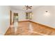 Spacious bedroom with hardwood floors, a ceiling fan, natural light, and wood trim around the windows and doorways at 317 William Dr, Benson, NC 27504