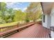 Spacious wooden deck with built-in seating and overlooks a large, grassy backyard with a white picket fence at 317 William Dr, Benson, NC 27504