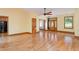 Spacious living room with light yellow walls, hardwood floors, wooden trim, and multiple entryways and windows at 317 William Dr, Benson, NC 27504