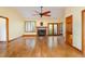 Large living room with hardwood floors, a brick fireplace, french doors, and a ceiling fan at 317 William Dr, Benson, NC 27504