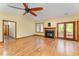 Bright living room featuring hardwood floors, a stone fireplace, french doors, and a ceiling fan at 317 William Dr, Benson, NC 27504