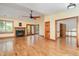 Bright living room featuring hardwood floors, a stone fireplace, french doors, and a ceiling fan at 317 William Dr, Benson, NC 27504