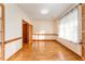 Bright room featuring hardwood floors, a large window with sheer curtains, and wooden trim at 317 William Dr, Benson, NC 27504