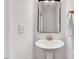 Modern bathroom with a pedestal sink, sleek mirror, and stylish fixtures at 3338 Prospect Parkway Pkwy, Durham, NC 27703