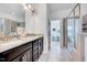 Well-lit bathroom with double sinks, granite countertops, and a glass-enclosed shower at 3338 Prospect Parkway Pkwy, Durham, NC 27703