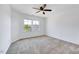 Bright bedroom with two large windows, neutral carpet, and a ceiling fan at 3338 Prospect Parkway Pkwy, Durham, NC 27703
