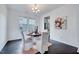 Bright dining room with a view of the backyard, table with four chairs, and dark hardwood floors at 3338 Prospect Parkway Pkwy, Durham, NC 27703