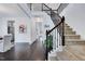 Bright entryway with beautiful hardwood floors, staircase with decorative wrought iron railing at 3338 Prospect Parkway Pkwy, Durham, NC 27703