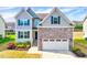 Charming two-story home with stone accents, a two-car garage, and a well-manicured front yard at 3338 Prospect Parkway Pkwy, Durham, NC 27703