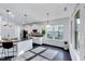 Spacious eat-in kitchen features white cabinetry, stainless appliances, granite counters and bar seating at 3338 Prospect Parkway Pkwy, Durham, NC 27703
