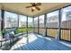 Cozy sunroom featuring a ceiling fan, comfortable seating, and screened windows at 3338 Prospect Parkway Pkwy, Durham, NC 27703