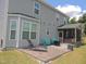 Home's backyard featuring a patio with lounge chairs and teal Adirondack chairs beneath a gray exterior at 3530 Winding Walk Ct, Raleigh, NC 27616