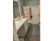 View of a functional bathroom with a single sink vanity, a tub with shower, and neutral decor at 3530 Winding Walk Ct, Raleigh, NC 27616
