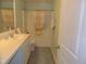 Well-lit bathroom featuring a single sink vanity, toilet, and a shower-tub combo with a curtain at 3530 Winding Walk Ct, Raleigh, NC 27616
