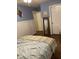 Relaxing bedroom with light blue walls, hardwood flooring, and a decorative wainscot at 3530 Winding Walk Ct, Raleigh, NC 27616