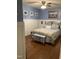 Comfortable bedroom with wainscoting, hardwood floors, and beach themed decor at 3530 Winding Walk Ct, Raleigh, NC 27616