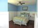 Inviting bedroom featuring blue walls, white wainscoting, and a cozy queen bed with colorful accents at 3530 Winding Walk Ct, Raleigh, NC 27616