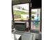 Inviting screened porch with a ceiling fan, a view to the stone patio, grill, and outdoor seating at 3530 Winding Walk Ct, Raleigh, NC 27616