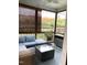 Cozy screened porch featuring a wicker sectional sofa, ceiling fan, and private backyard views at 3530 Winding Walk Ct, Raleigh, NC 27616