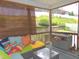 Relaxing screened porch with cushioned seating, a glass table, and a view of the landscaped yard at 3530 Winding Walk Ct, Raleigh, NC 27616