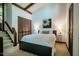Cozy bedroom with queen bed, wood-look closet doors, and natural light for a peaceful retreat at 3719 W Cornwallis Rd, Durham, NC 27705