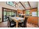 Bright dining room with modern light fixtures and view to kitchen and outdoor greenery at 3719 W Cornwallis Rd, Durham, NC 27705