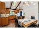 Modern dining room highlighting vaulted ceilings, a skylight, and a seamless connection to the kitchen at 3719 W Cornwallis Rd, Durham, NC 27705