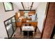 Bright dining area boasts wood table, black chairs, and a convenient kitchen pass-through for easy serving at 3719 W Cornwallis Rd, Durham, NC 27705