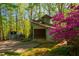 Unique home exterior featuring a beautiful sunroom and vibrant landscaping at 3719 W Cornwallis Rd, Durham, NC 27705