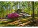 Unique home exterior featuring a beautiful sunroom and vibrant landscaping at 3719 W Cornwallis Rd, Durham, NC 27705