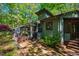 Charming home with a sunroom addition nestled amongst beautiful, mature trees offering serenity and seclusion at 3719 W Cornwallis Rd, Durham, NC 27705