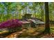 Unique home exterior featuring a beautiful sunroom and vibrant landscaping at 3719 W Cornwallis Rd, Durham, NC 27705