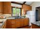 Cozy kitchen with stainless sink under window offering serene views at 3719 W Cornwallis Rd, Durham, NC 27705