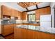 Charming kitchen featuring granite countertops, modern appliances, and wooden cabinets at 3719 W Cornwallis Rd, Durham, NC 27705
