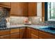 Close up view of kitchen granite countertops and natural wood cabinets at 3719 W Cornwallis Rd, Durham, NC 27705