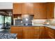 Stylish kitchen featuring granite countertops, wood cabinets, and stainless steel appliances at 3719 W Cornwallis Rd, Durham, NC 27705