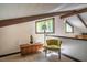 Living area with exposed beams, carpet, a side table, a chair, and beautiful natural light at 3719 W Cornwallis Rd, Durham, NC 27705