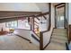 Upstairs living area features exposed beams, wood accents, carpet, and access to a bathroom at 3719 W Cornwallis Rd, Durham, NC 27705