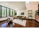 Bright living room with hardwood floors and a stunning view from a large window at 3719 W Cornwallis Rd, Durham, NC 27705